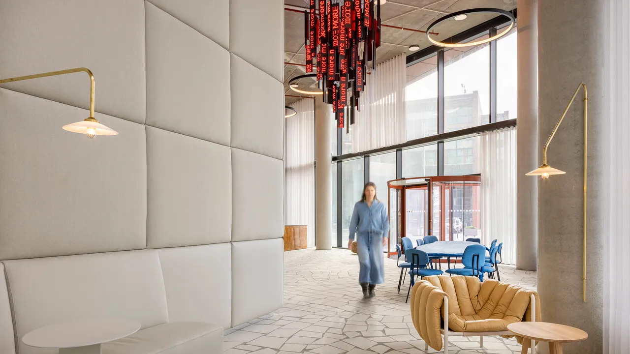 The Orato entrance hall with padded walls and a red light installation