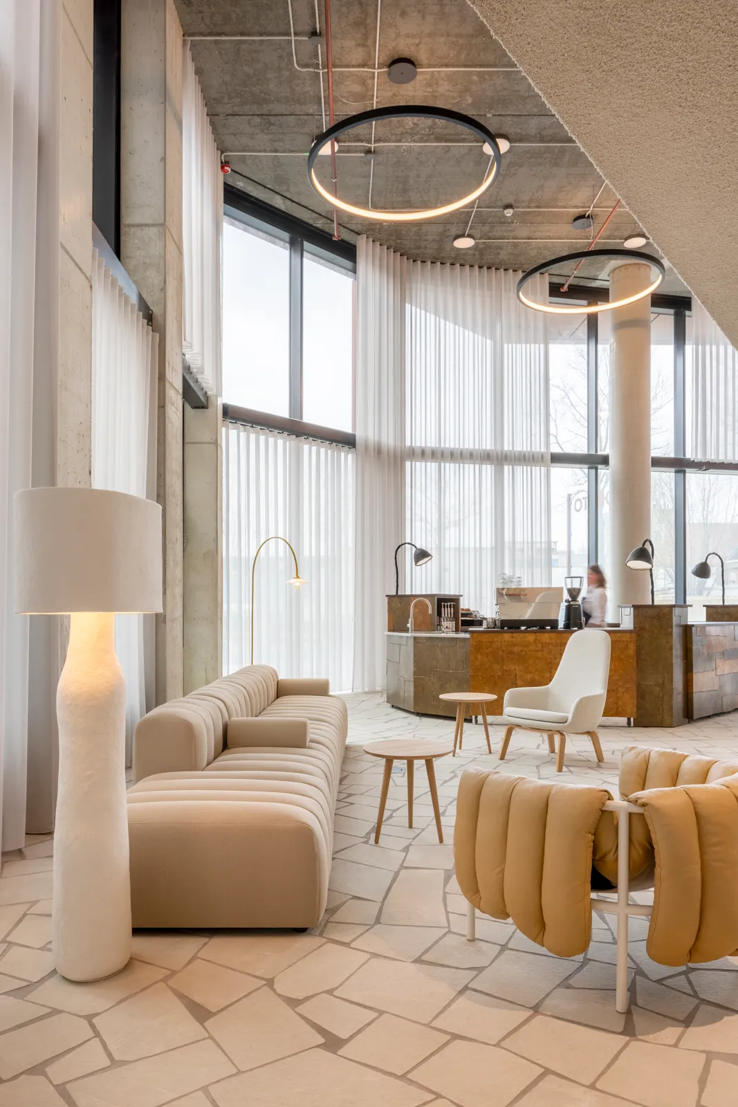 The coffee corner of De Huismeesters in the Orato lobby, with armchairs and tall windows